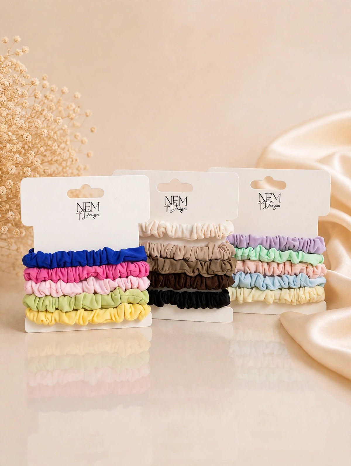 Scrunchie sets on NEM Designs cards in Bright, Neutral, and Pastel colors